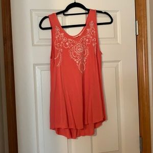 Sleeveless flowy tank with embroidery detail.